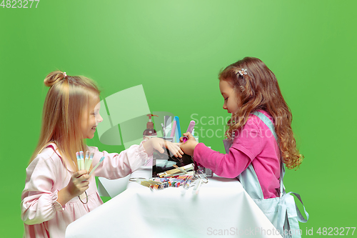 Image of Little girl dreaming about future profession of nails manicure artist