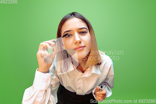 Image of Little girl dreaming about future profession of makeup and hairstyle artist