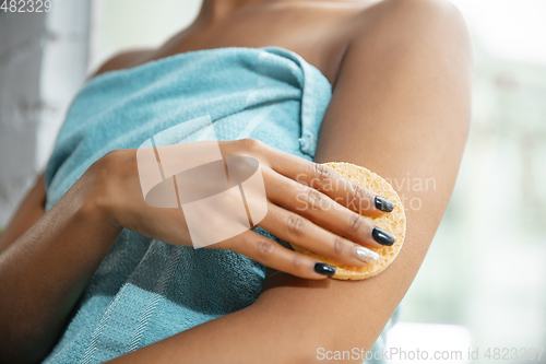 Image of Beauty Day. Woman doing her daily skincare routine at home