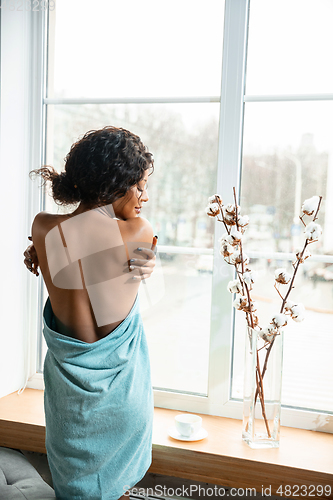 Image of Beauty Day. Woman doing her daily skincare routine at home