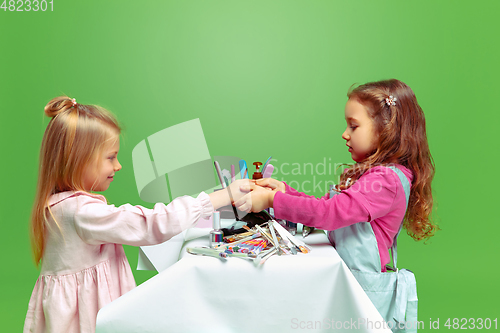 Image of Little girl dreaming about future profession of nails manicure artist