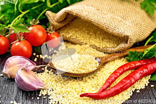 Image of Couscous raw in spoon on board