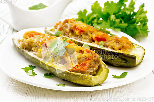 Image of Cucumber stuffed with meat and vegetables on board