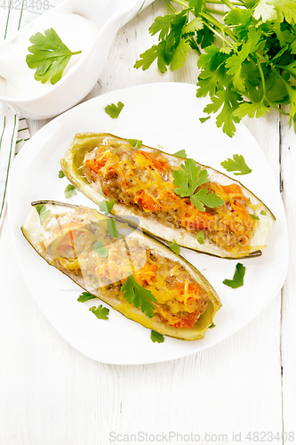 Image of Cucumber stuffed with meat and vegetables on board top