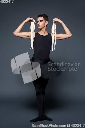 Image of handsome ballet artist in tutu skirt