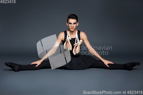 Image of handsome ballet artist in tutu skirt