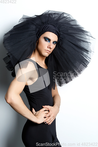 Image of handsome ballet artist in tutu skirt