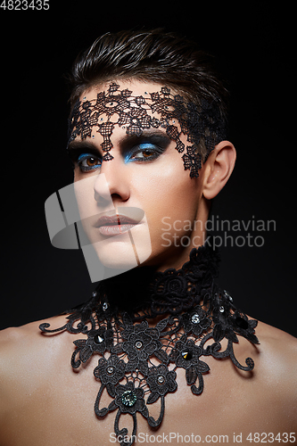 Image of young man wiht dark makeup