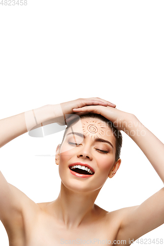 Image of girl with sun drawing on forehead isolated on white