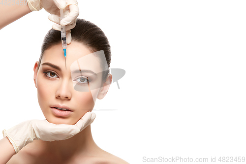 Image of beautiful girl getting face injection isolated on white