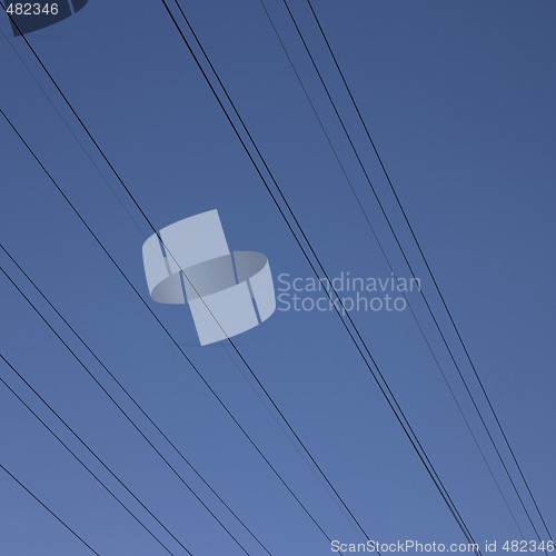 Image of black electric wires in the blue sky