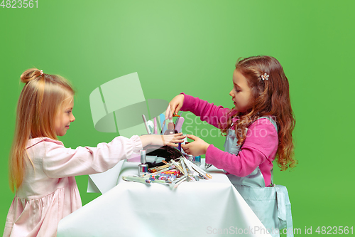 Image of Little girl dreaming about future profession of nails manicure artist