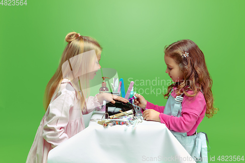 Image of Little girl dreaming about future profession of nails manicure artist