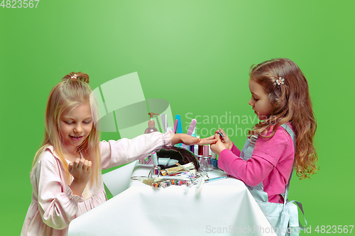 Image of Little girl dreaming about future profession of nails manicure artist