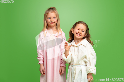 Image of Little girl dreaming about future profession of cosmetologist