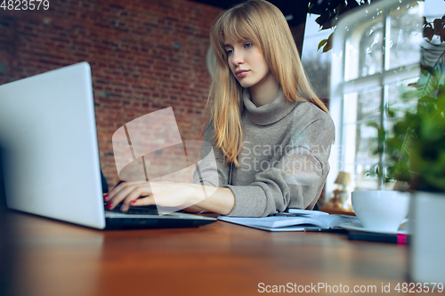 Image of Beautiful caucasian business lady working in office with laptop