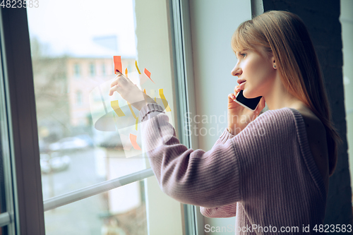 Image of Beautiful caucasian business lady working in office, open-space