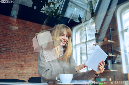 Image of Beautiful caucasian business lady working in office with laptop