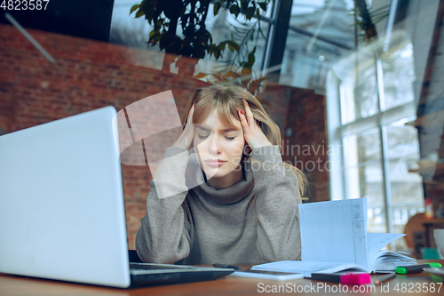 Image of Beautiful caucasian business lady working in office with laptop