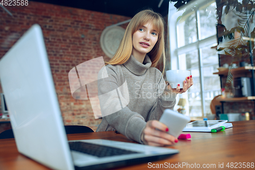 Image of Beautiful caucasian business lady working in office with laptop