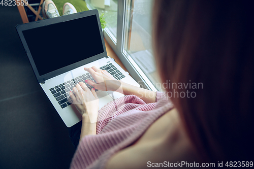 Image of Beautiful caucasian business lady working in office with laptop