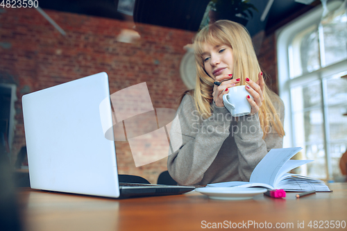 Image of Beautiful caucasian business lady working in office with laptop