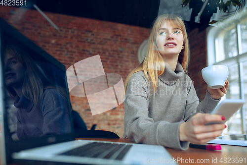 Image of Beautiful caucasian business lady working in office with laptop