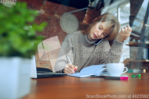 Image of Beautiful caucasian business lady working in office with laptop