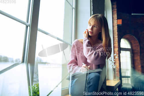 Image of Beautiful caucasian business lady working in office, open-space