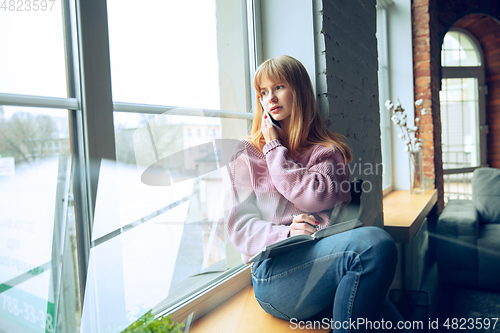 Image of Beautiful caucasian business lady working in office, open-space