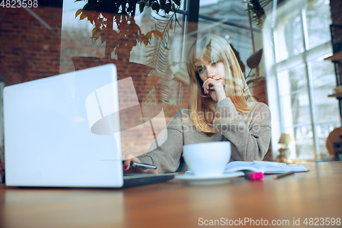 Image of Beautiful caucasian business lady working in office with laptop