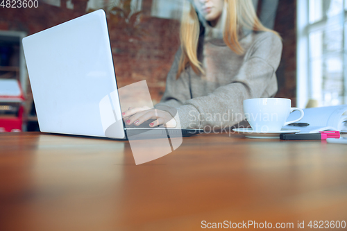 Image of Beautiful caucasian business lady working in office with laptop