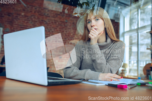 Image of Beautiful caucasian business lady working in office with laptop