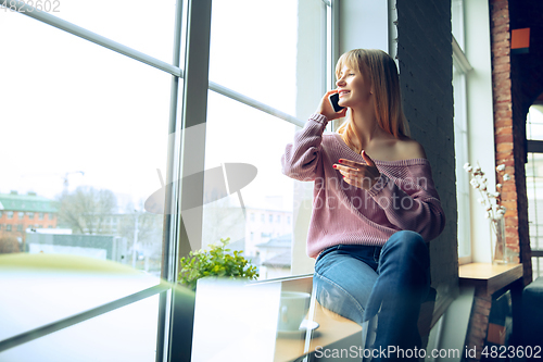Image of Beautiful caucasian business lady working in office, open-space