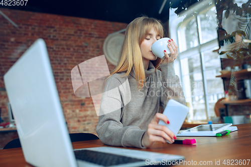 Image of Beautiful caucasian business lady working in office with laptop