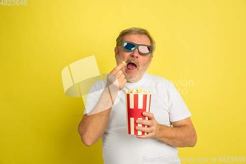 Image of Caucasian senior man\'s portrait isolated on yellow studio background