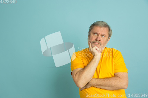 Image of Caucasian senior man\'s portrait isolated on blue studio background