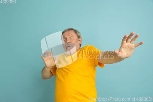 Image of Caucasian senior man\'s portrait isolated on blue studio background