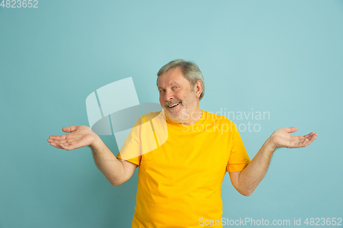 Image of Caucasian senior man\'s portrait isolated on blue studio background