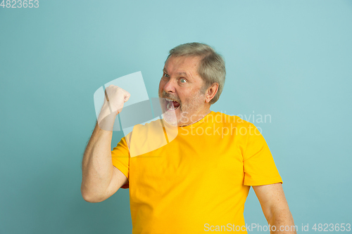 Image of Caucasian senior man\'s portrait isolated on blue studio background