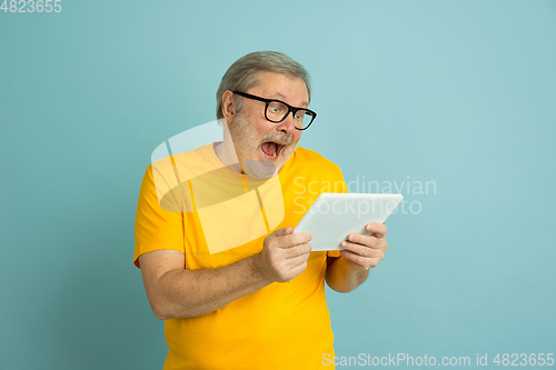 Image of Caucasian senior man\'s portrait isolated on blue studio background