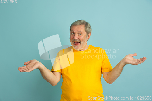 Image of Caucasian senior man\'s portrait isolated on blue studio background