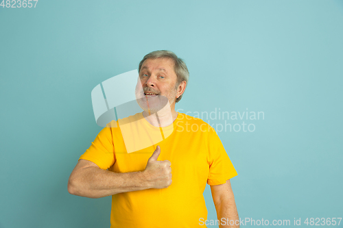 Image of Caucasian senior man\'s portrait isolated on blue studio background