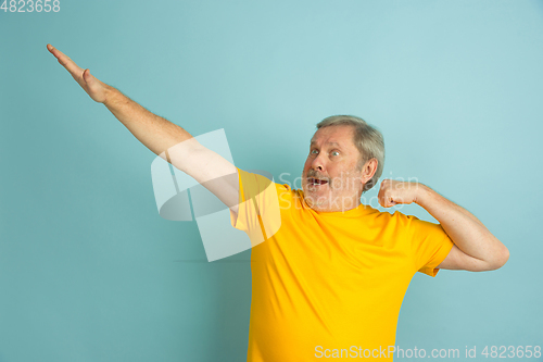 Image of Caucasian senior man\'s portrait isolated on blue studio background