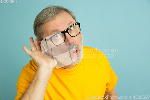 Image of Caucasian senior man\'s portrait isolated on blue studio background