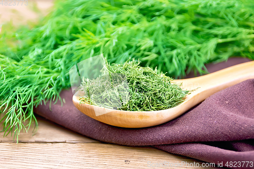 Image of Dill dry in spoon on wooden board