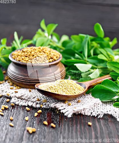 Image of Fenugreek in spoon and bowl with green leaves on board