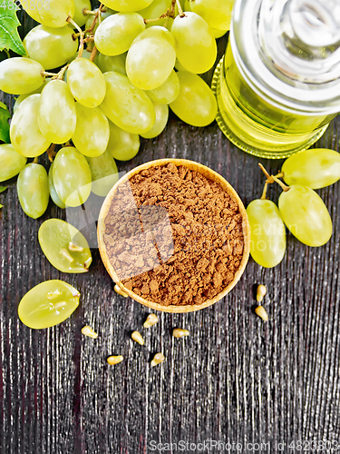 Image of Flour grape seed in bowl on black board top