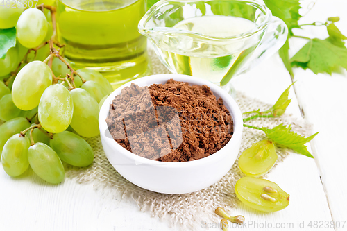 Image of Flour grape seed in bowl on board