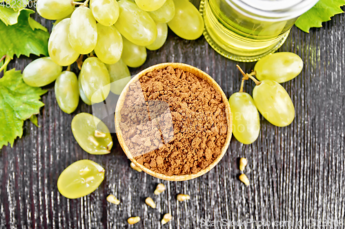 Image of Flour grape seed in bowl on dark board top